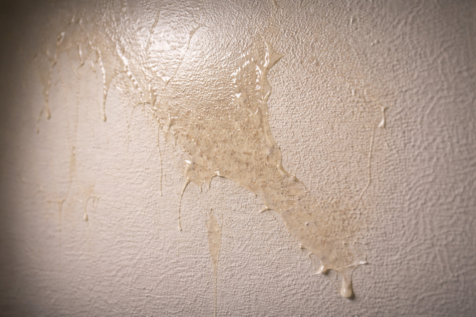Residual wallpaper glue left on the wall after removal